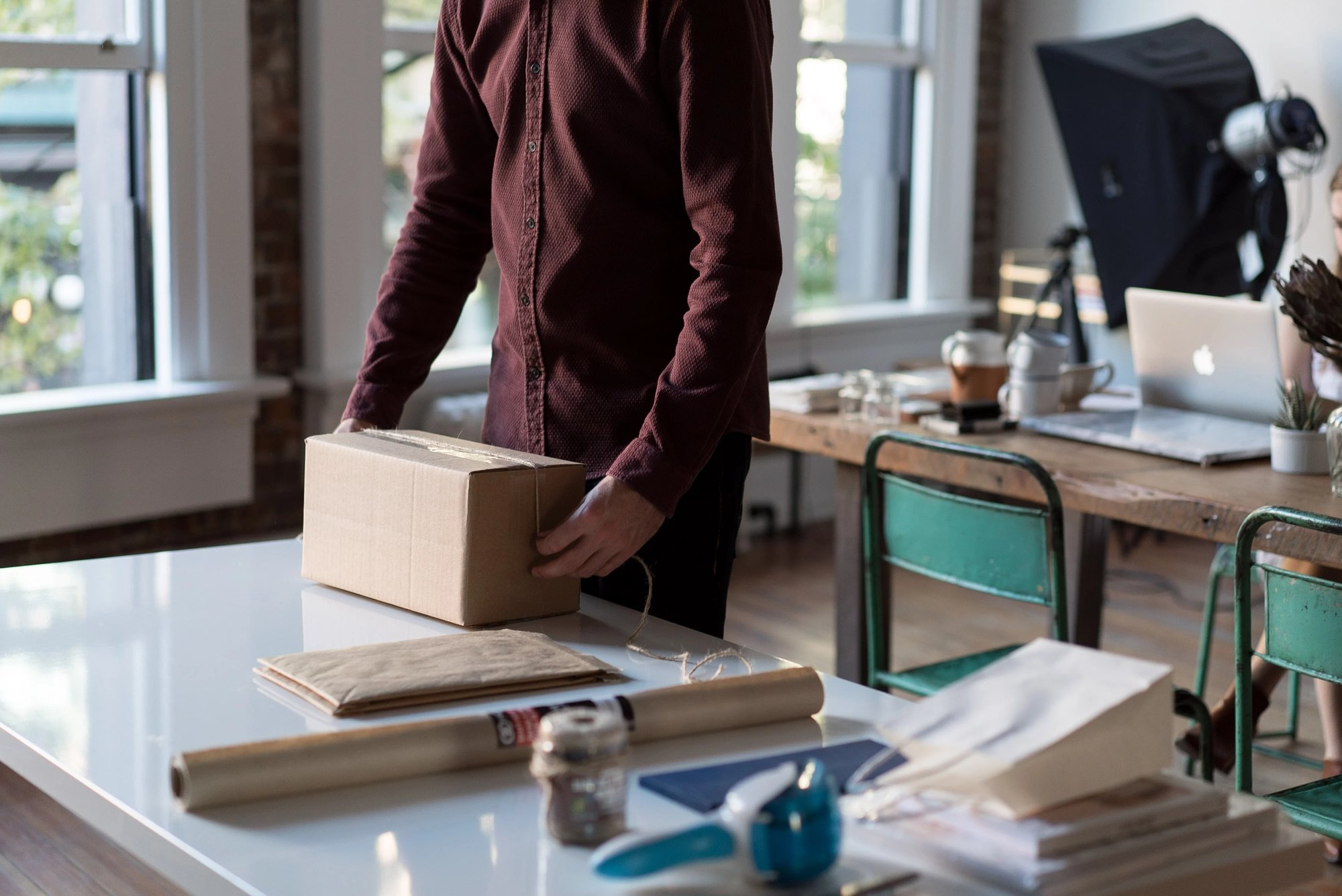 delivery man wrapping box